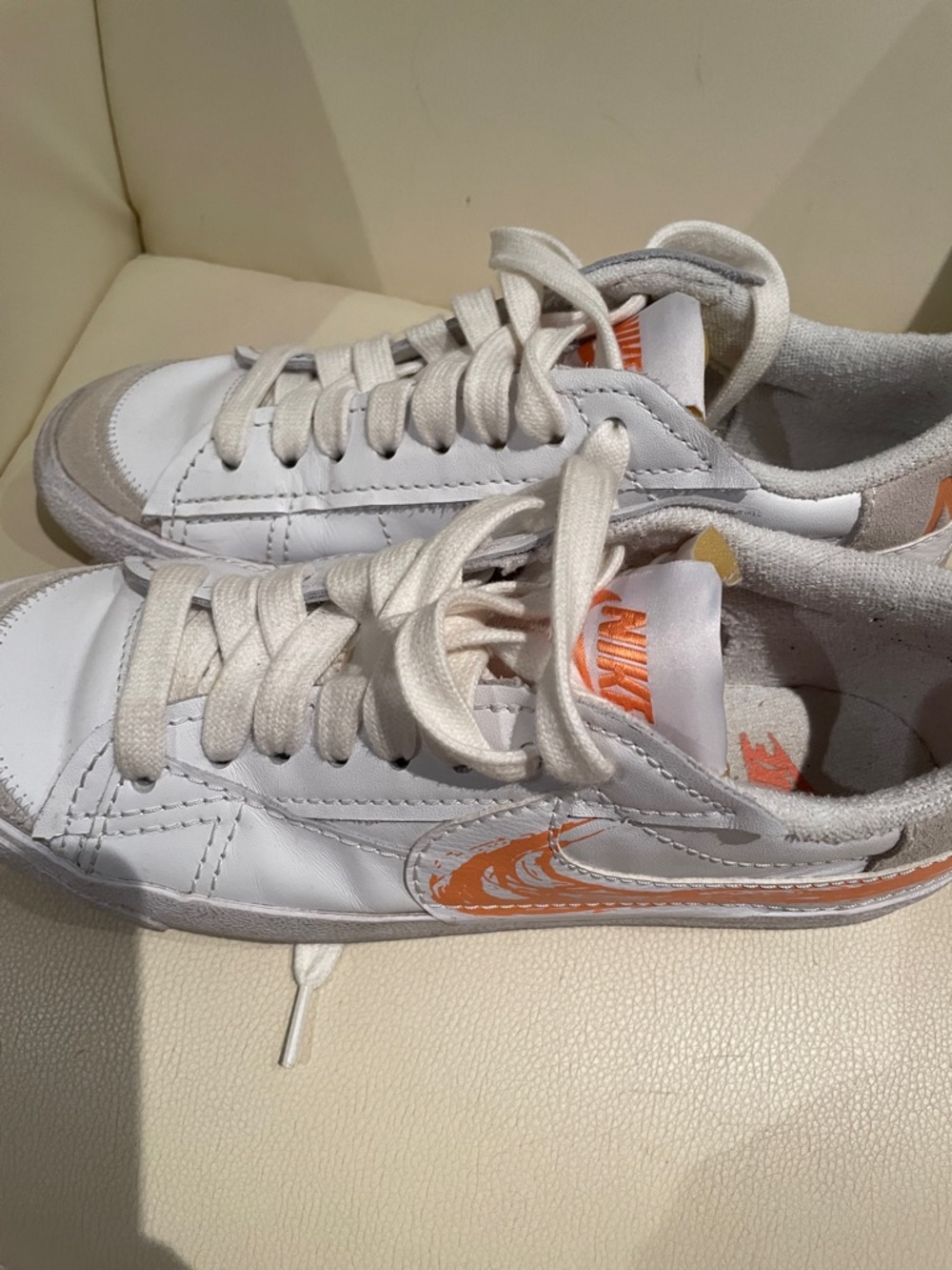 Nike White Leather Low-Top Sneakers with Orange Swoosh Detail